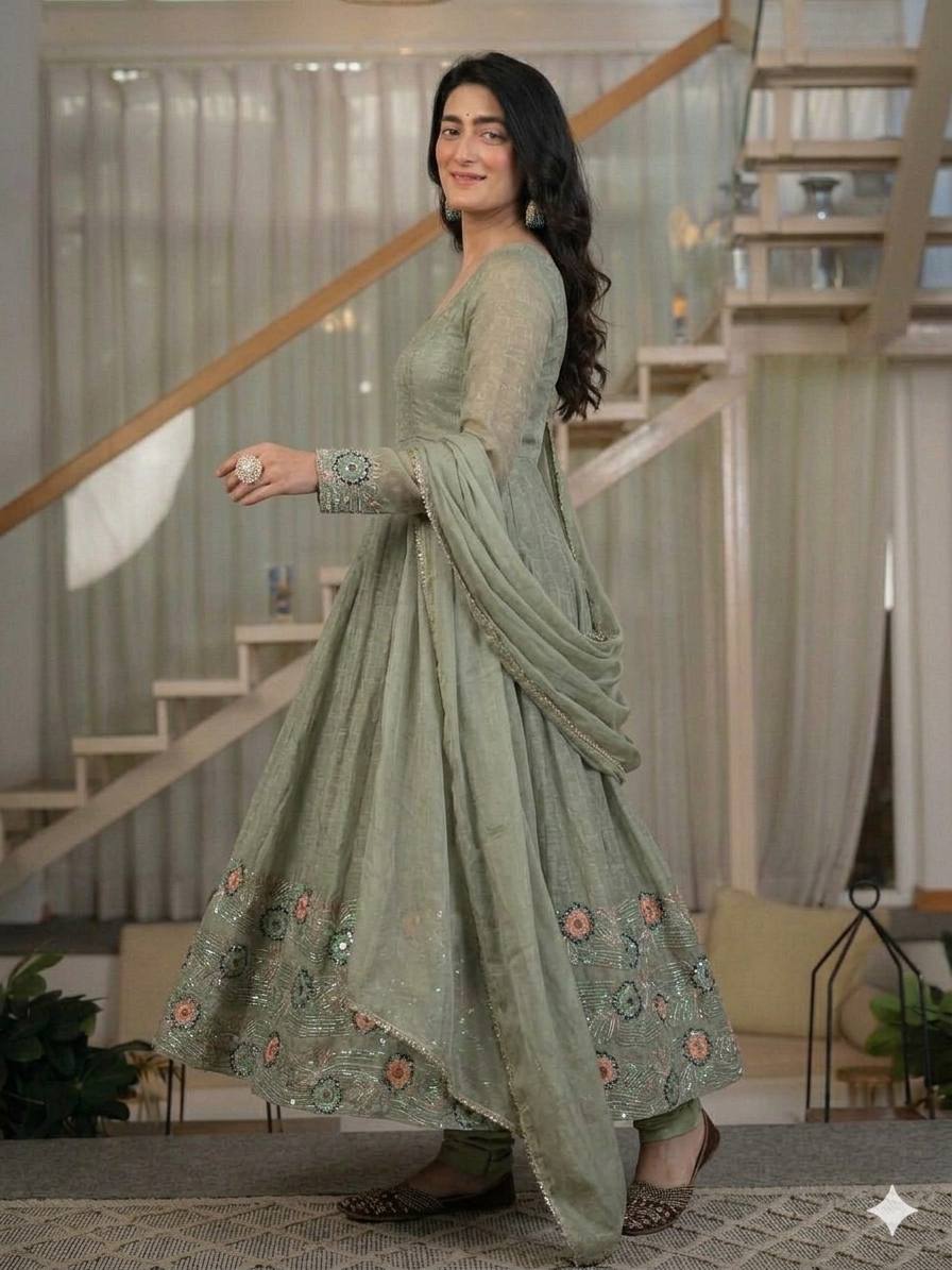 Ethereal Mehendi Green Flared Anarkali Suit Set Adorned with Luminous Sequined Floral Motifs, Embroidered Cuffs, and an Ornate Heritage Hem